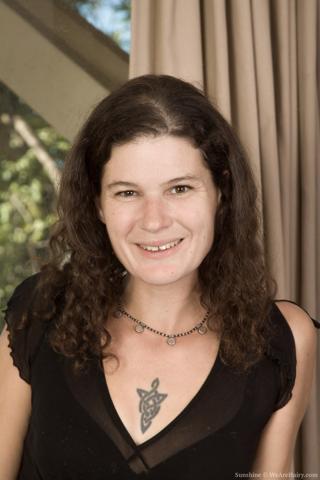 Sunshine in We Are Hairy set Sunshine gets naked and sexy on her red sofa